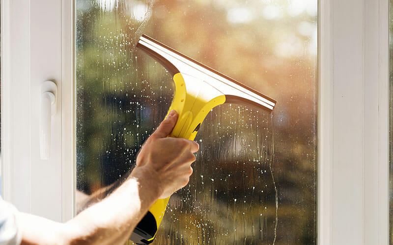 Internal window cleaning with squeegee on glass